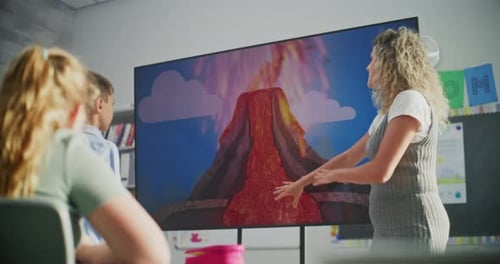 Teacher Explains Volcano Graphic to Students in Classroom