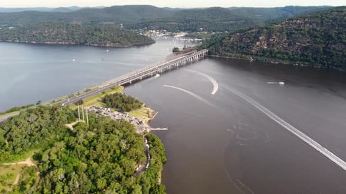 Drone pan aerial shot of Brooklyn Bridge freeway motorway with cars and speed boats Hawkesbury River