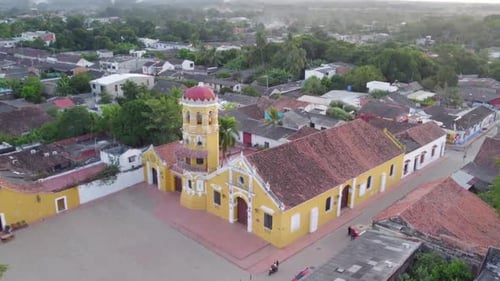 The streets, lined with whitewashed buildings and red-tiled roofs, take on a rich, amber hue, while