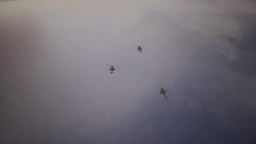 Military Helicopters Flying in Formation Against a Cloudy Sky