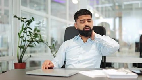 Businessman Experiencing Severe Neck Pain and Discomfort Working at Office Desk
