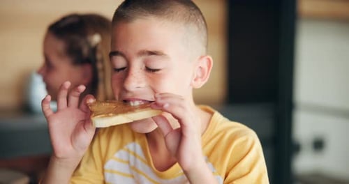 Boy Enjoying a Sandwich at Home