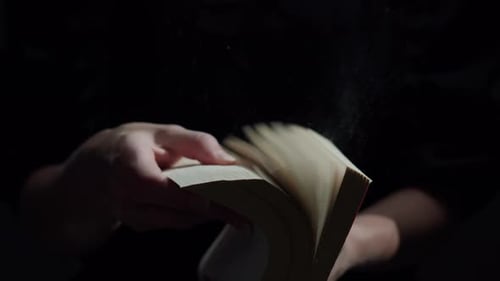 Flipping Through Pages of Old Book with Dust