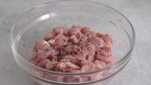 Preparing Seasoned Chicken in Glass Bowl