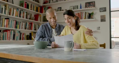 Couple Looks At Documents Together At Home
