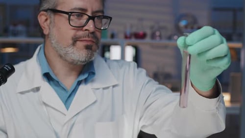 Scientist Examining Test Tube in Bright Lab