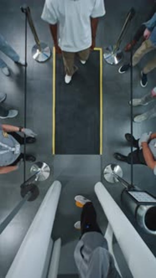 Top View on Queue of Diverse People Passengers Passing Through Xray Metal Detector Scanner Gates
