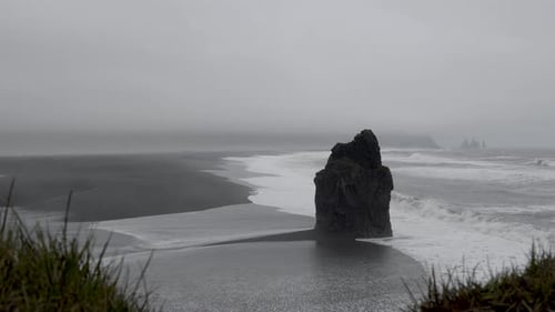 Waves Splashing Onto Rough Black Boulder Near The Shore In Reynisfjara Black Sand Beach In Iceland W