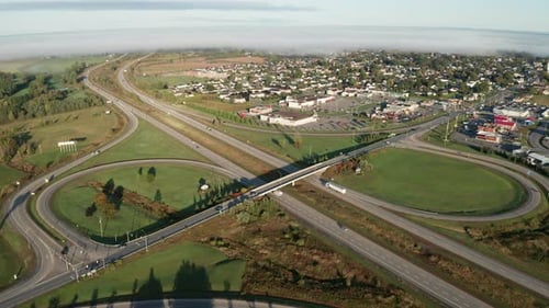 Dangerous changing driving conditions with environmental hazard. Fog in distance obscures road and l