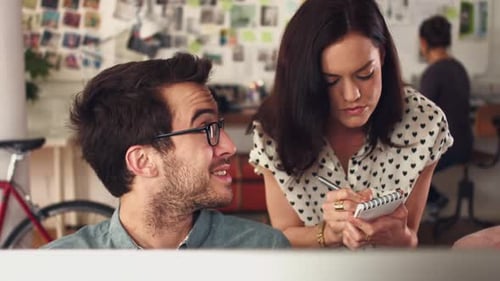 4k video footage of a group of designers working together on a computer in an office