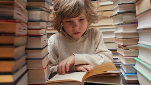 Handsome Little Child Flips Through the Book Pages in Library Elementary School Boy Enjoying Reading