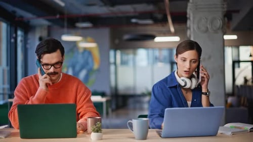 Young Adults Working at Laptops in Modern Office