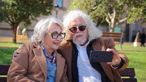 Happy Senior Couple Taking a Selfie in a Park
