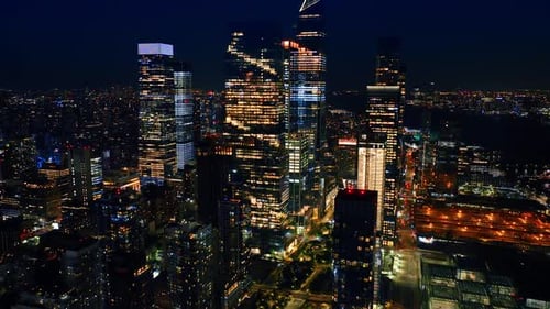 Rising to the tops of magnificent skyscrapers. Amazing New York full of lights at night.