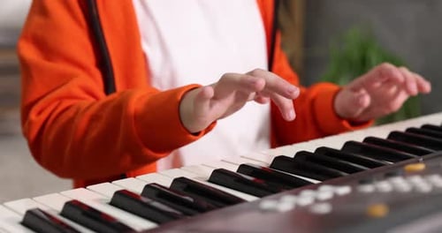Child Practices Piano at Home, Close Up View