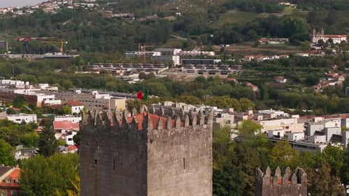 Aerial sequence of Guimarães Castle with Portuguese flag, Portugal