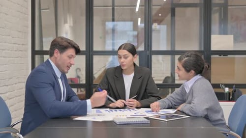 Team of Professionals Meeting and Discussing Data