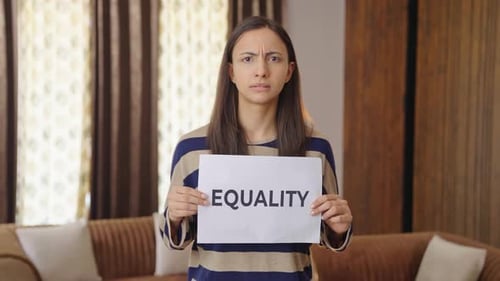 Woman Holds Equality Sign Indoors