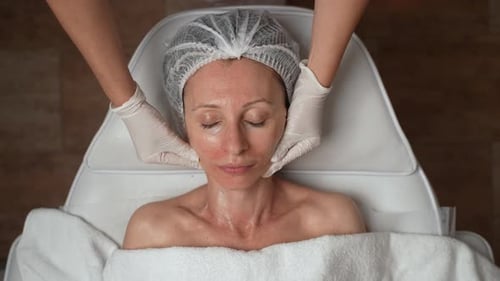 Woman Receiving Relaxing Facial Massage at a Spa