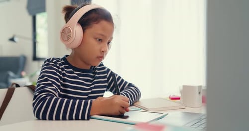 Young Child Using Tablet for Studying at Home