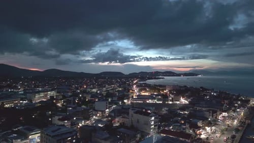 Dusk Blue Hour Over Coastal Town with Lights, Aerial Trucking Pan