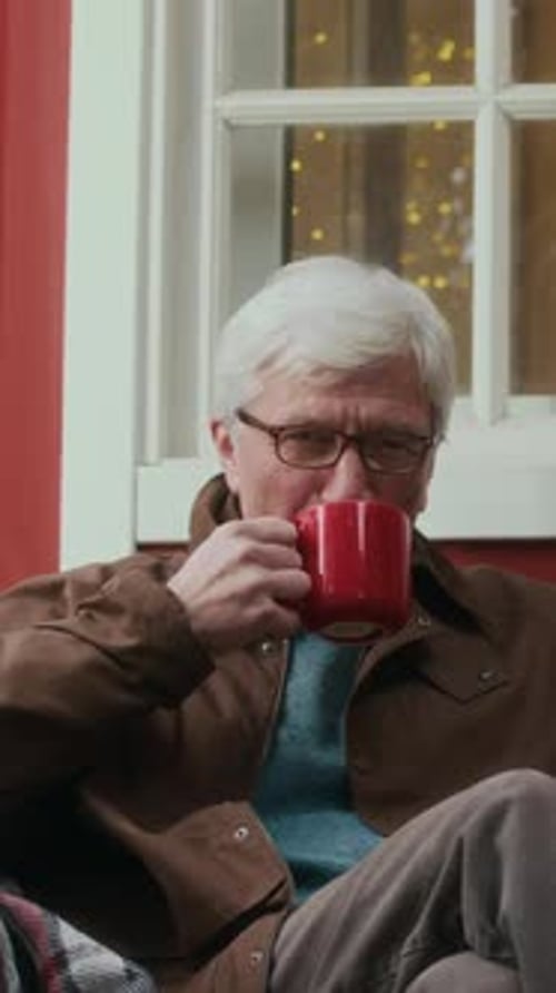 Smiling Senior Man Drinking from Mug at Home