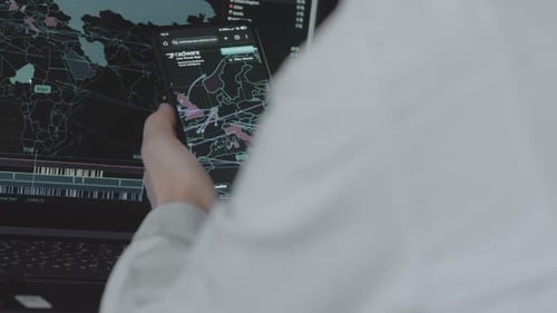 Person Viewing World Map on Phone and Computer