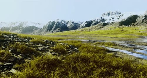Mountain Landscape with Snow Capped Peaks and Flowing River Among Grassland