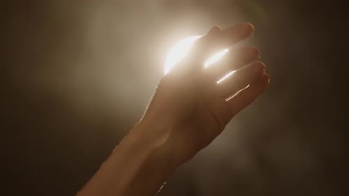 Hand Reaching Towards the Light