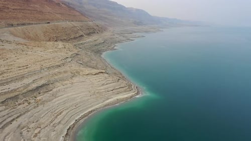 Aerial video over the coastline of the Dead Sea on the Israeli side, at sunset