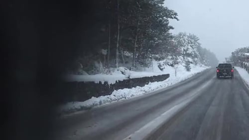 Car Driving In Road At The Center Of Snow-Covered Forest In Istanbul Turkey - medium shot