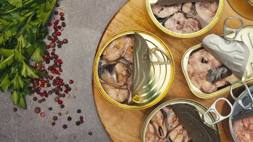 Opening Metal Cans with Canned Fish and Pate on Table Top View Canned Salmon and Tuna Macro Canning