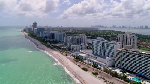 Turquoise ocean and white sand beach flyover by drone in beautiful Miami Florida