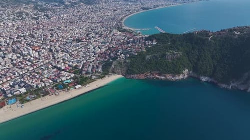 Aerial Video of a Tropical White Beach With Soft Sand Azure Waves and a Modern City Overlooking the