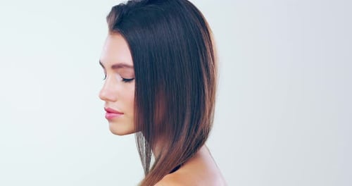 4k video footage of a beautiful young woman with gorgeous hair posing in the studio