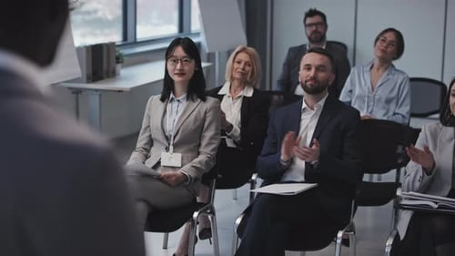 Group of Adults Clapping at a Conference