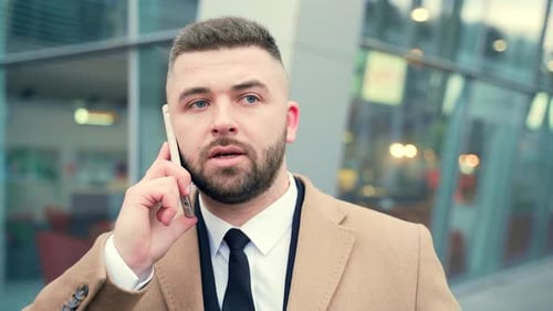 portrait of happy business man talking on mobile phone or smartphone. Face close up of handsome male
