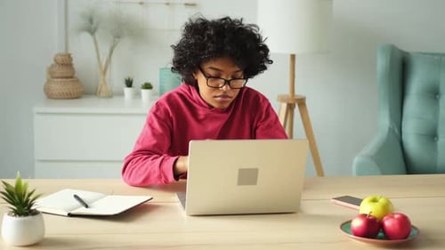African American Girl at Home Office Relaxing Stretching Hands and Body Taking Break From Work on