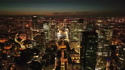 Aerial View of Modern Urban Borough at Night Backwards Reveal of La Defense Skyscrapers Paris France