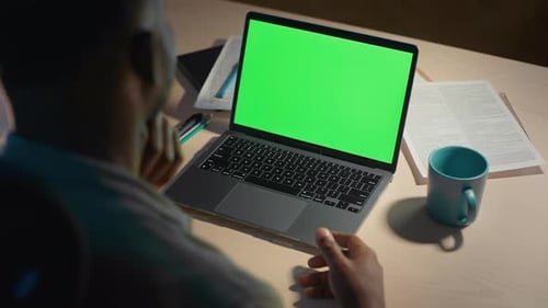 Afro Man Having Video Call on Laptop with Green Display