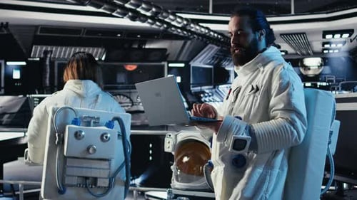 Astronaut Reviewing Onboard Analytics on Laptop Before Stepping Out of Station