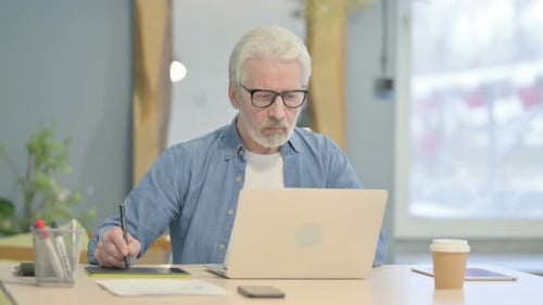 Senior Man Working with Stylus and Tablet