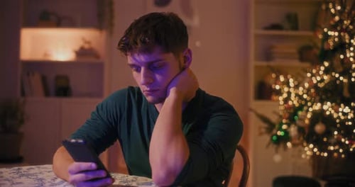 Man with Mobile Phone at Christmas Time