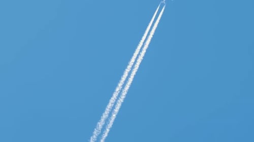 Passenger airplane at cruising altitude against blue sky.