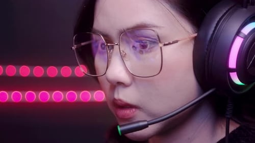 close up of professional Streamer and gamer wearing glasses playing online