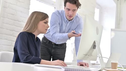 Angry Creative Team Discussing Work on Desktop in Office