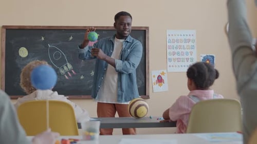 Teacher Giving Astronomy Lesson with Primary School Students