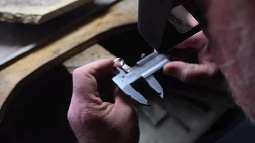 Jeweler Measuring Ring Size with Calipers Close Up