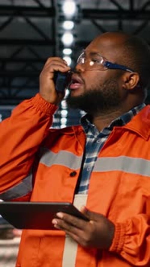 Vertical Video African American Professional Worker Using Walkie Talkie Radio in Industry Plant