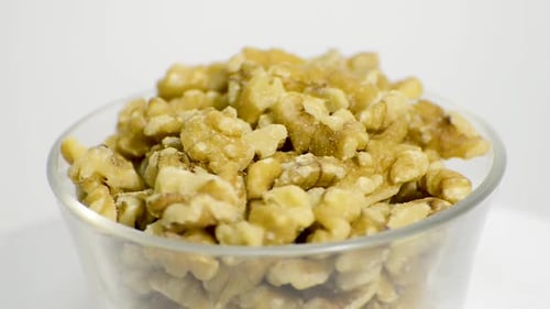 Rotating Close Up of Walnuts in a Glass Bowl